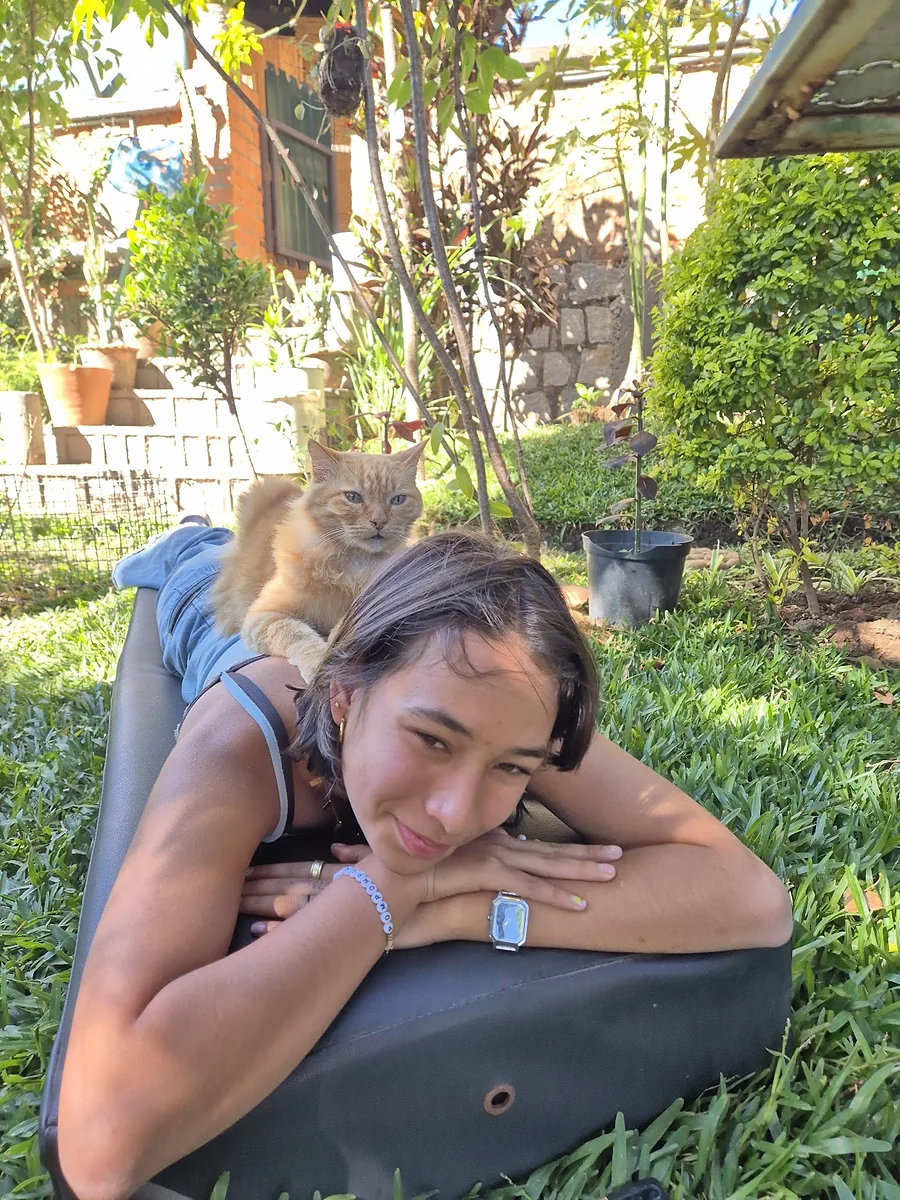A guest resting on the lawn of the B&B garden with the house cat