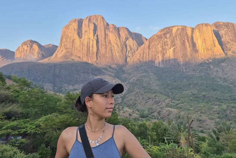 A traveller in front of the granite cliffs of Tsaranoro at sunset