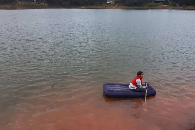 A traveller paddles an air mattress on Lake Rasoabe at Manambato