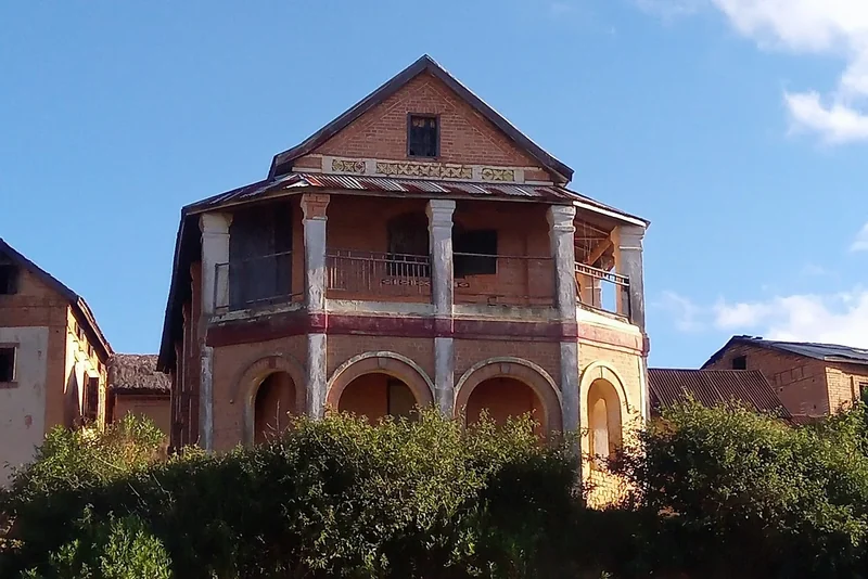 An old brick house with columns and balconies on a hill in Antananarivo